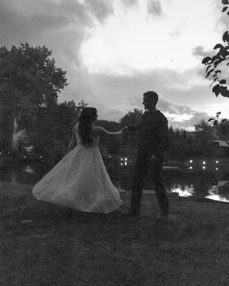 Lucas and Kori dancing by the pond at dusk